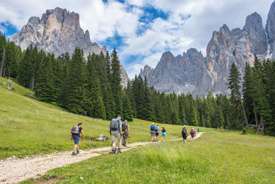 People in mountains against sky