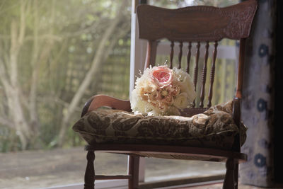 Close-up of bouquet on chair