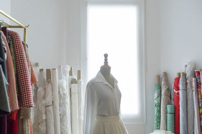Female mannequin amidst clothes in store