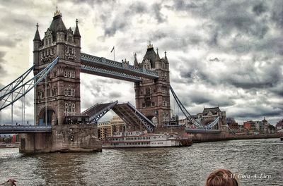 View of bridge over river against cloudy sky