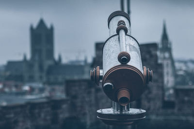 Coin-operated binoculars against buildings in city