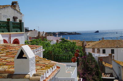 Town by sea against clear sky