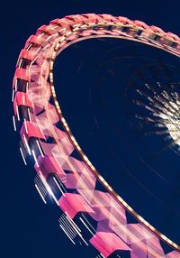 Low angle view of illuminated ferris wheel against sky at night