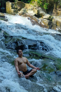 Full length of shirtless man in water