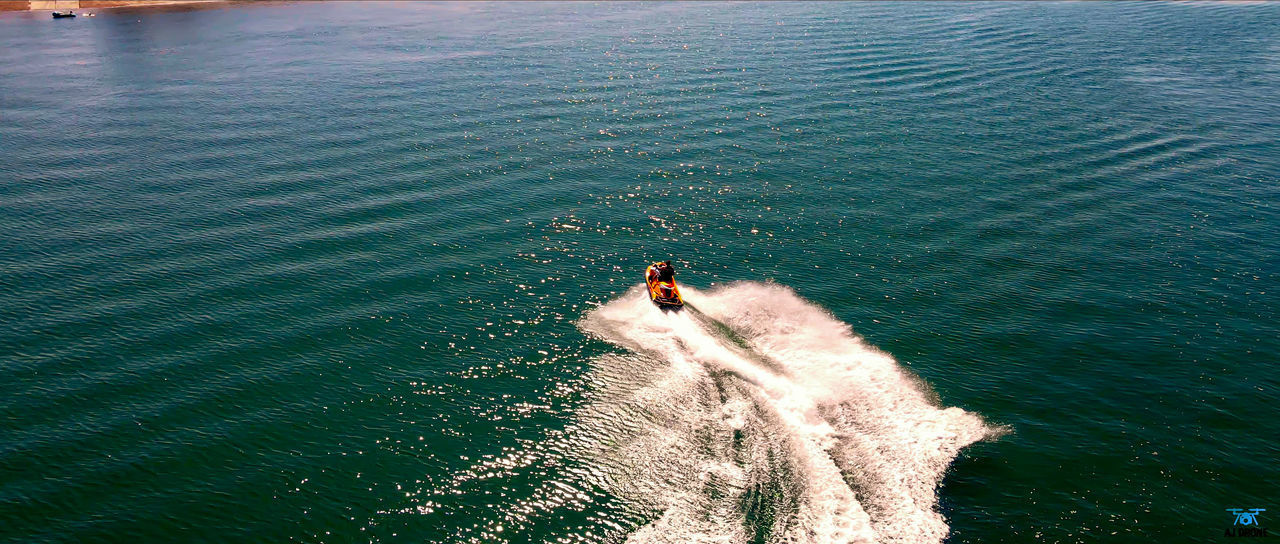 HIGH ANGLE VIEW OF PEOPLE BY SEA