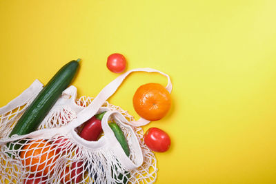 Close-up of fruits against yellow background