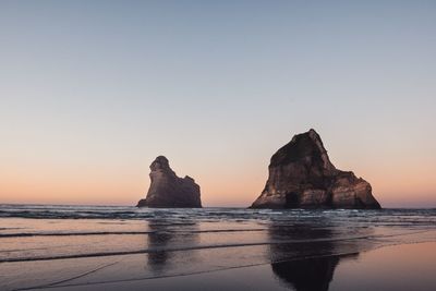 Scenic view of sea against clear sky during sunset