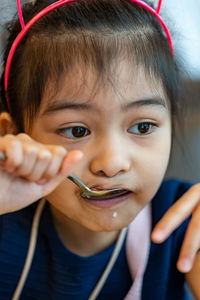 Close-up of cute girl eating food at restaurant