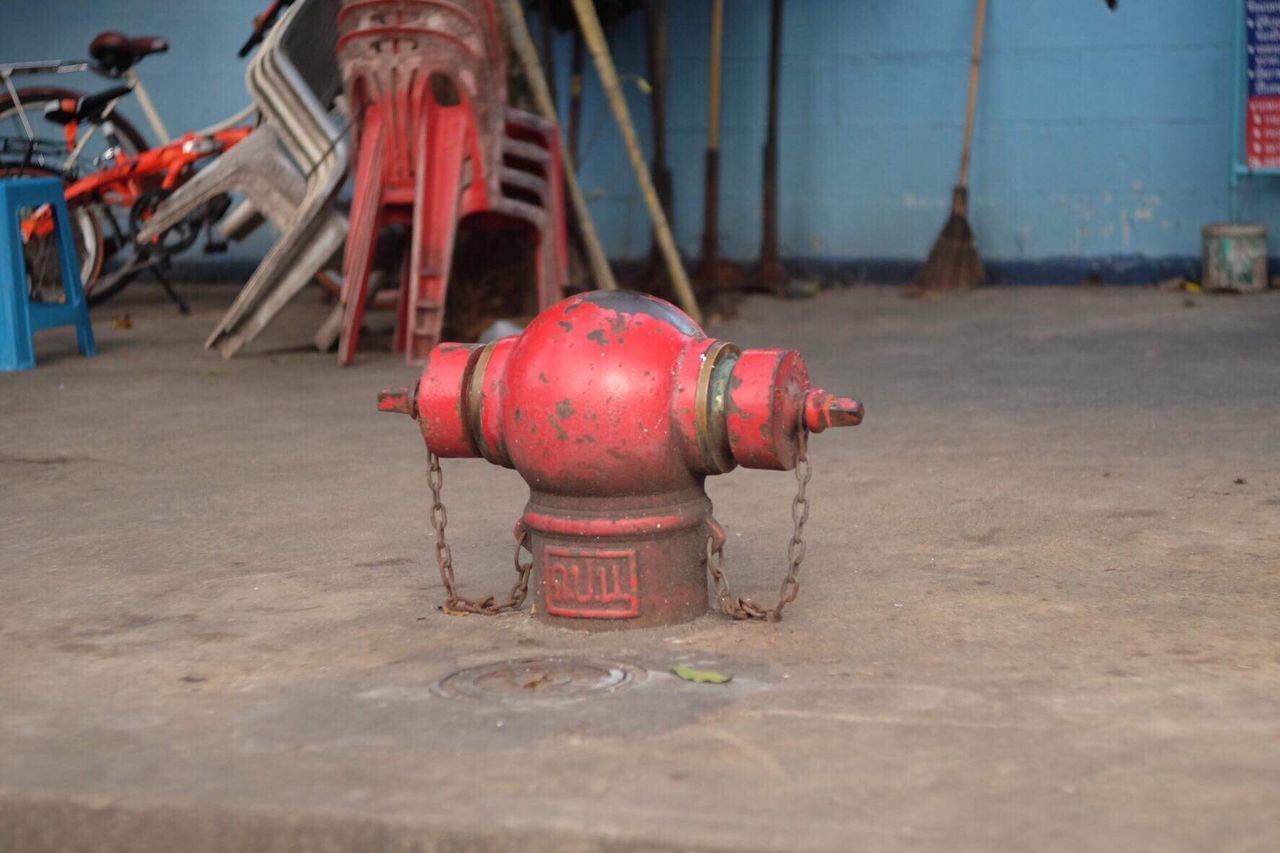 CLOSE-UP OF FIRE HYDRANT ON RED METAL STRUCTURE