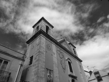 Low angle view of clock tower against sky