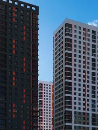 Low angle view of buildings against blue sky