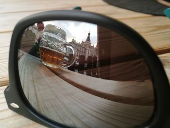 Reflection of beer glass on sunglasses