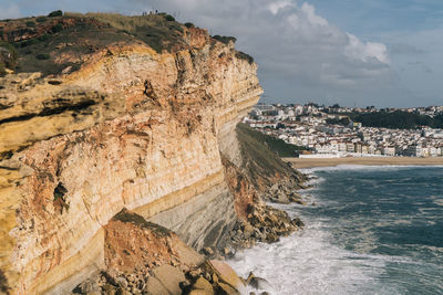 Scenic view of sea and mountains against sky