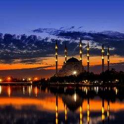 Reflection of illuminated mosque in water