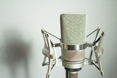 Close-up of microphone against wall