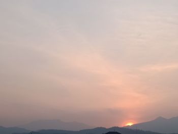 Scenic view of silhouette mountain against romantic sky