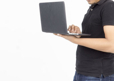 Midsection of man using smart phone against white background