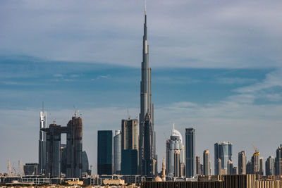 View of skyscrapers against cloudy sky