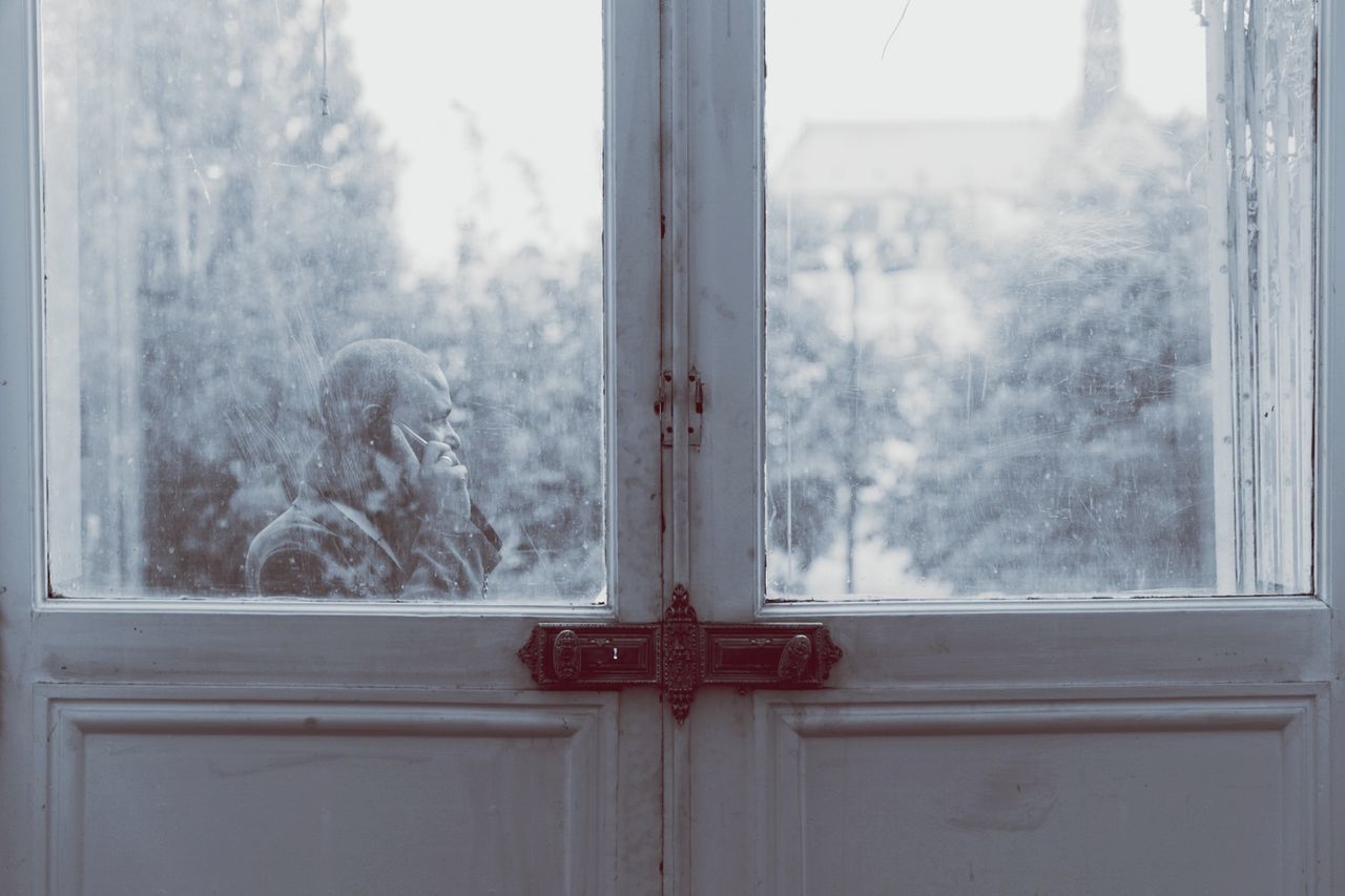 window, glass - material, transparent, indoors, door, close-up, text, closed, communication, day, window sill, weather, safety, red, focus on foreground, cold temperature, no people, built structure, tree, protection