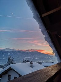 Scenic view of snowcapped mountain against sky during sunset