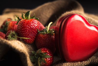Close-up of strawberries with heart shape on table