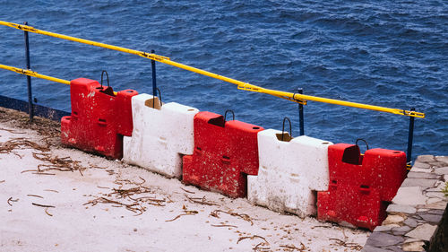 Close-up of red umbrella on beach