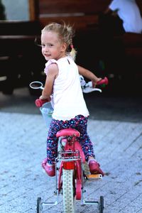 Full length of cute girl riding motorcycle