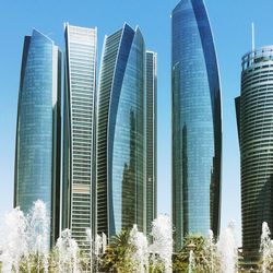 Low angle view of modern buildings against clear blue sky