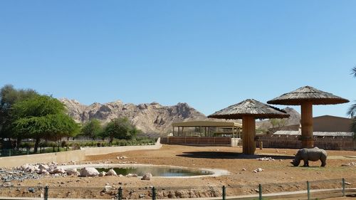 Built structure on beach against clear blue sky