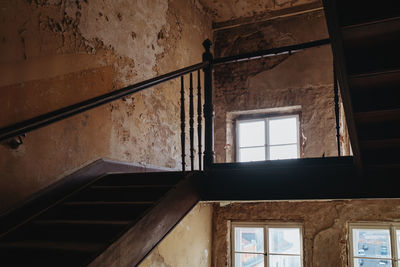 Damaged staircase in abandoned apartment building