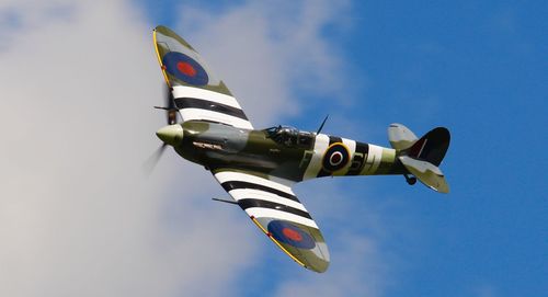 Low angle view of airplane flying against sky