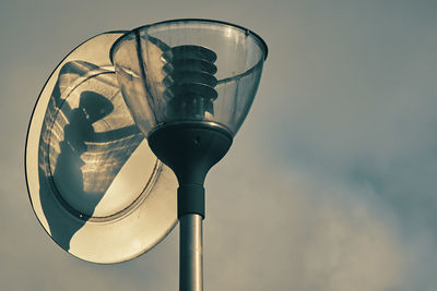 Low angle view of street light against sky