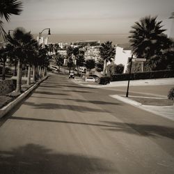 Empty road with buildings in background