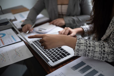 Midsection of business colleagues working at office