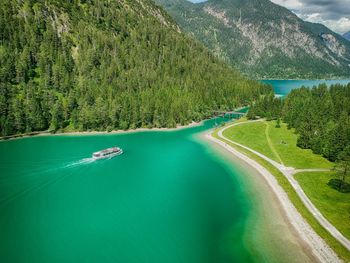 A small tourist ship entering a connection between two lakes in austria