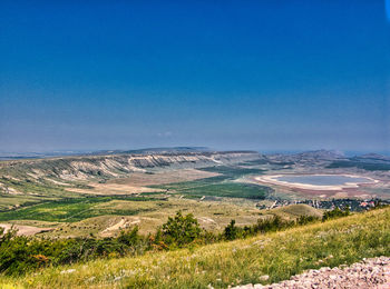 Scenic view of landscape against clear blue sky