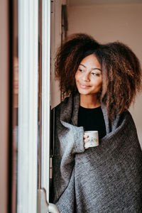 Portrait of smiling young woman at home