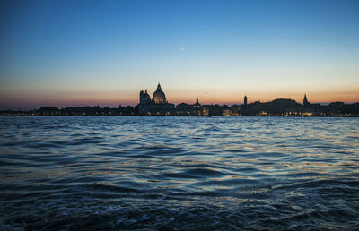 View of buildings in city at sunset