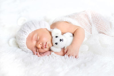 Portrait of cute baby boy sleeping on bed