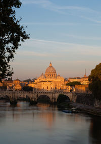 Bridge over river with buildings in background