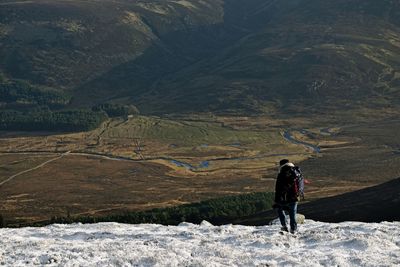 Rear view of man standing on mountain