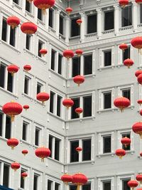 Low angle view of chinese lanterns hanging against white building