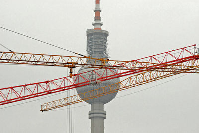 Low angle view of communications tower against sky