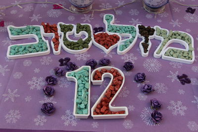 High angle view of multi colored stones arranged on table