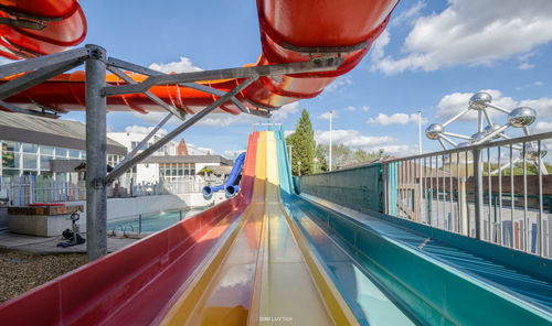 Panoramic view of ferris wheel in city against sky