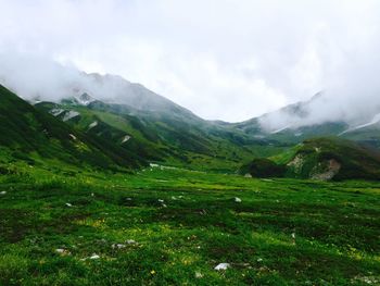 Scenic view of mountains against cloudy sky