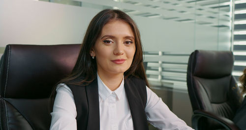 Portrait of satisfied business woman looking into camera after signing big project. 