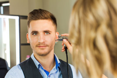 Portrait of young man holding camera