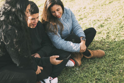 Hispanic family spending quality time together in a local park on a beautiful, sunny day. 