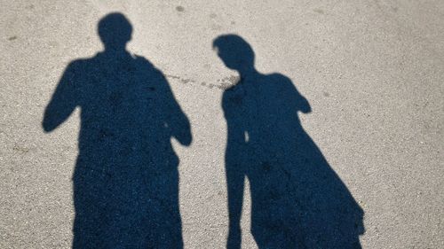 Shadow of people on street